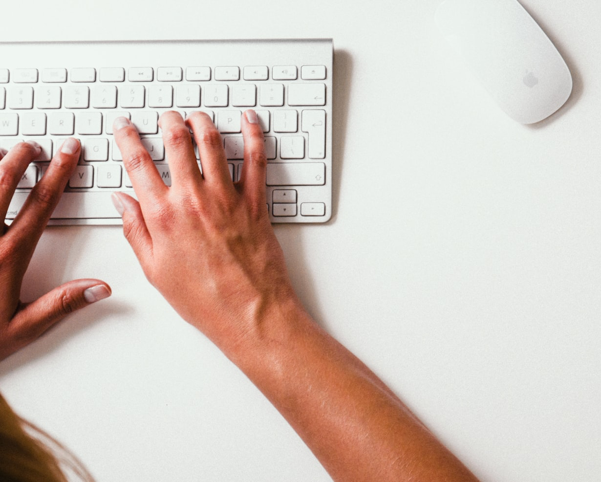 person typing on Apple Cordless Keyboard