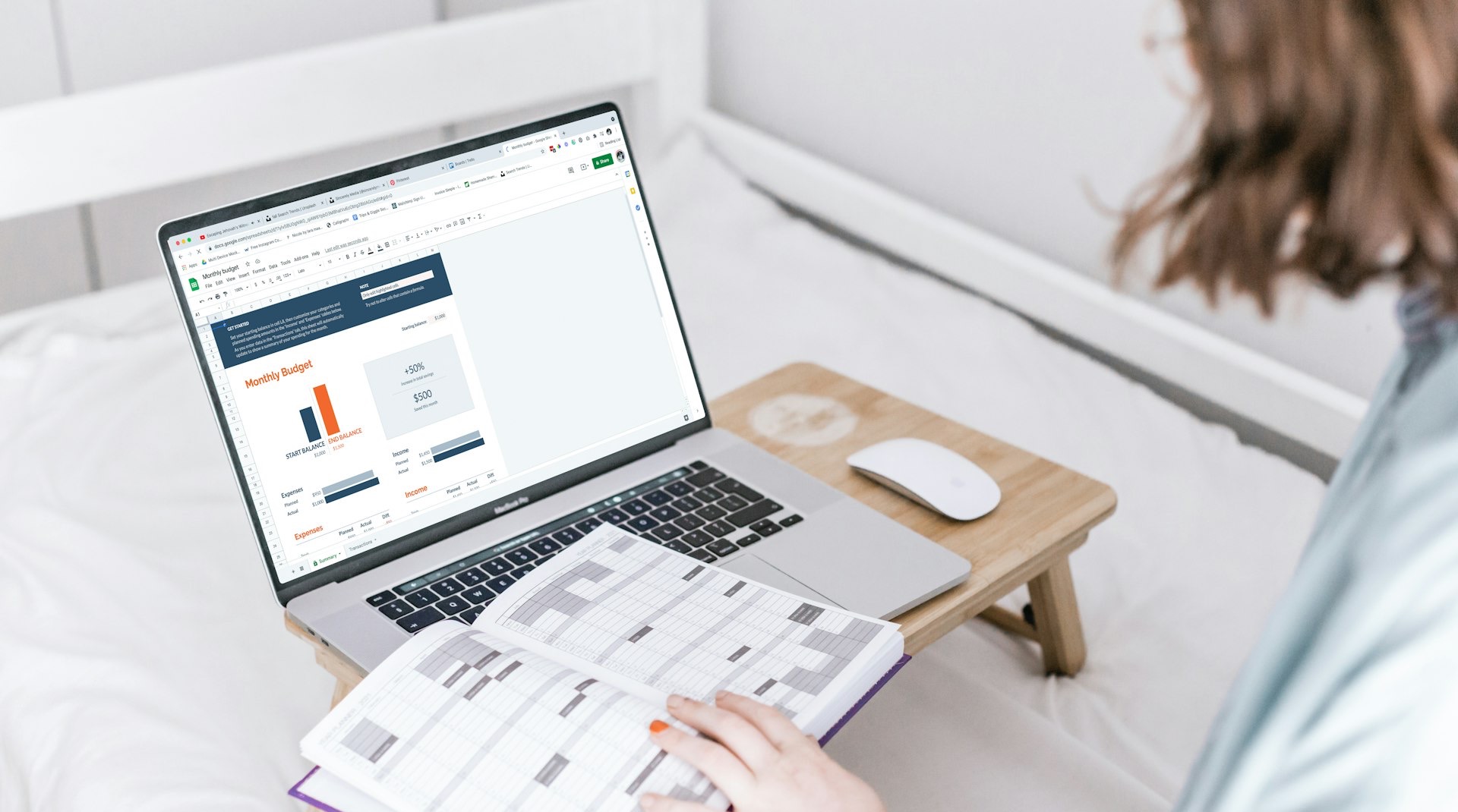 a person sitting on a bed with a laptop